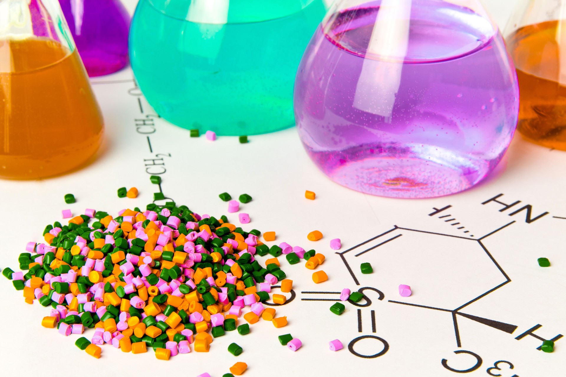 Plastic raw material in granules against the background of Chemical Laboratory and reagents. Polypropylene, Ethylene, Polypropylene research in laboratory conditions